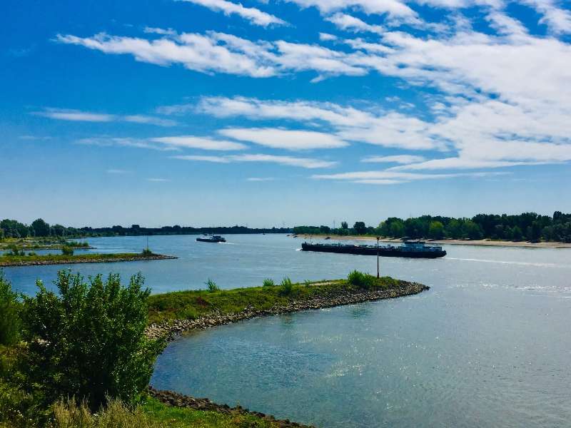 Rivierlandschap met boten en blauwe lucht, Nederland