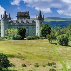 Kasteel met torens omringd door groen landschap.